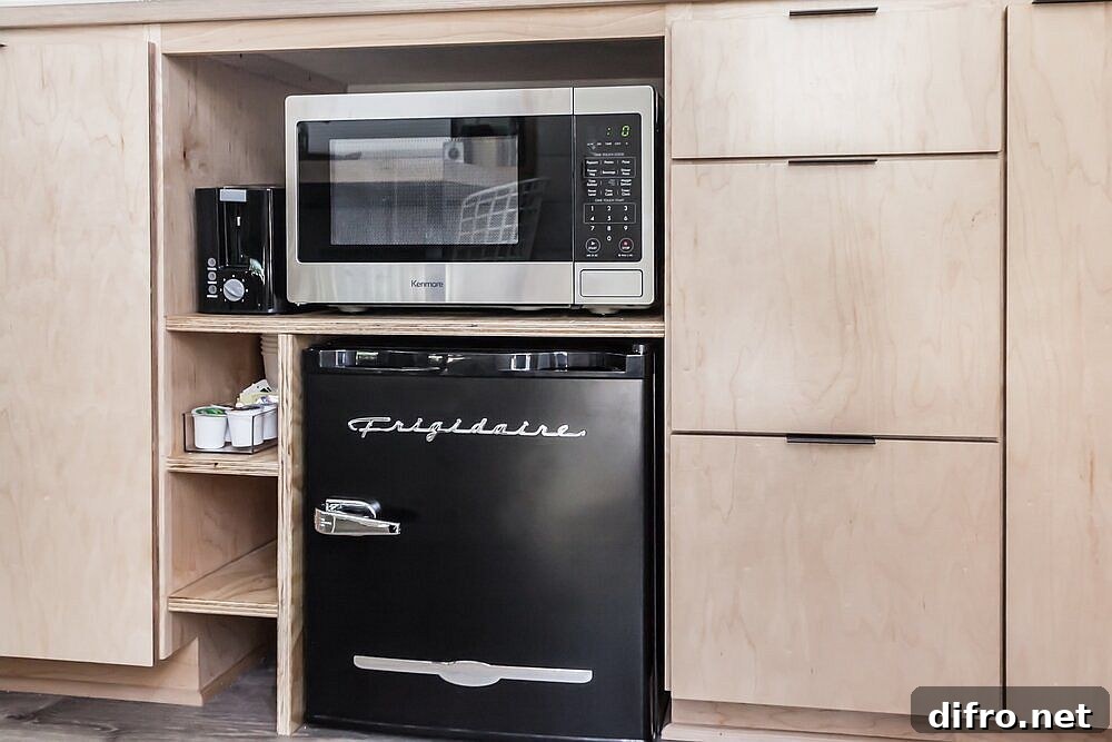 Microwave and small refrigerator integrated into cabinets