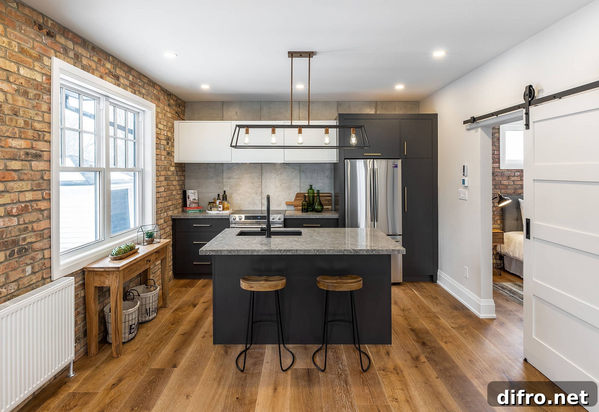 Balanced modern and industrial styles in modest kitchen with brick wall
