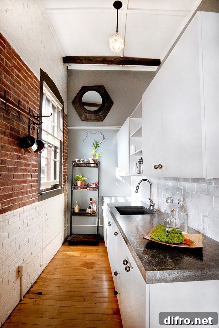 Narrow kitchen with half-whitewashed brick wall