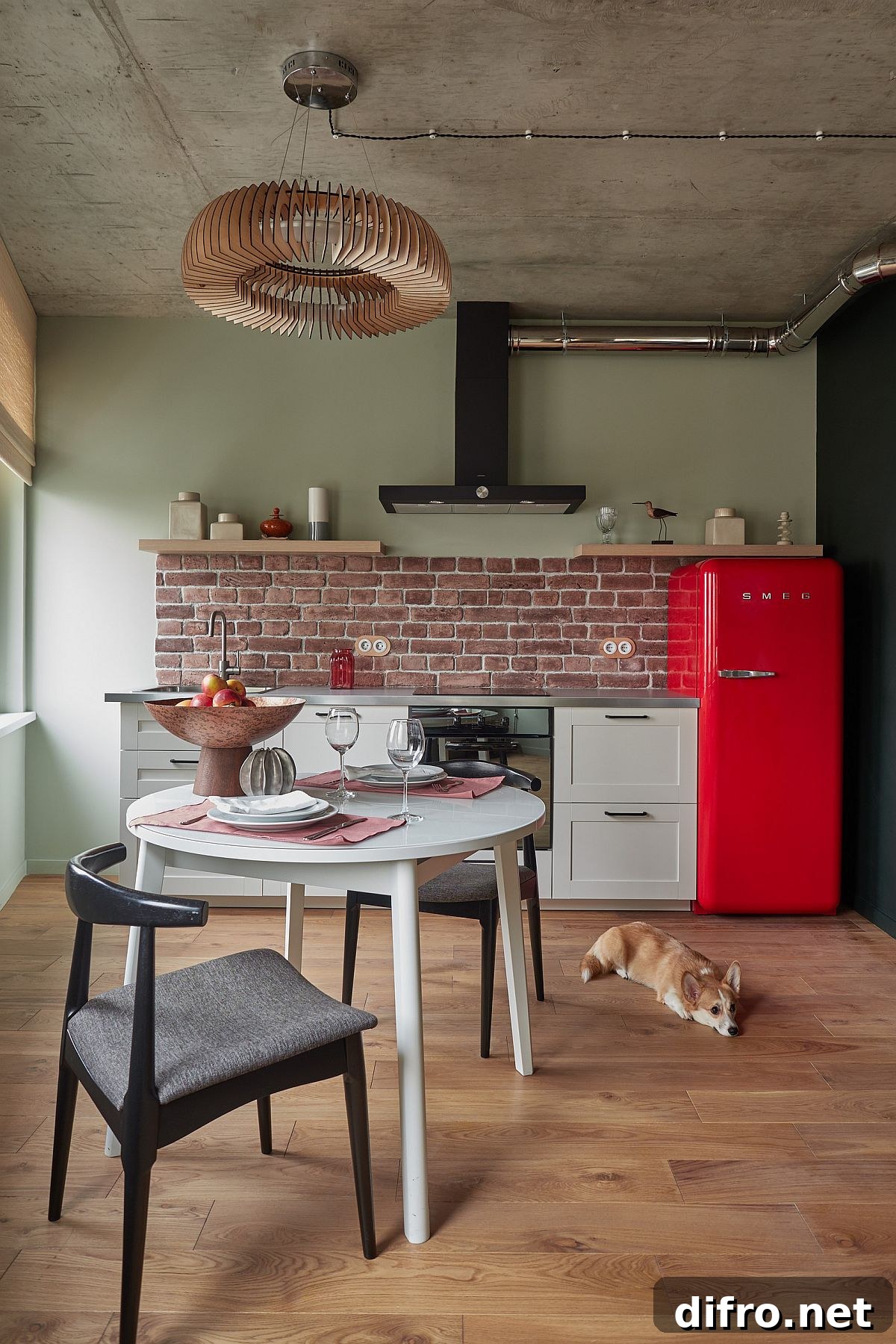 Small industrial kitchen with a red refrigerator and retro touches