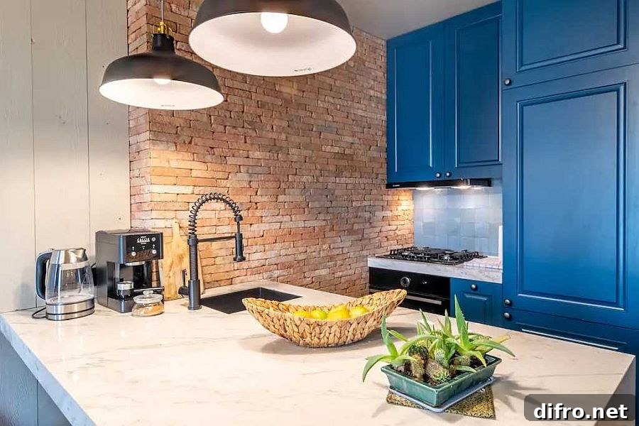 Apartment kitchen with blue cabinets and exposed brick section