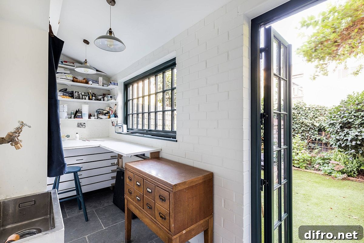 Tiny white craft room with brick walls and corner desk