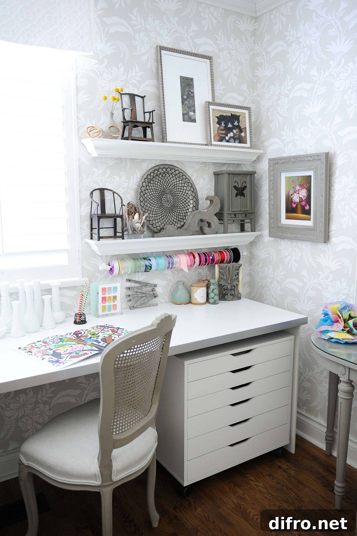 Floral wallpaper and clever storage ideas in a small craft room