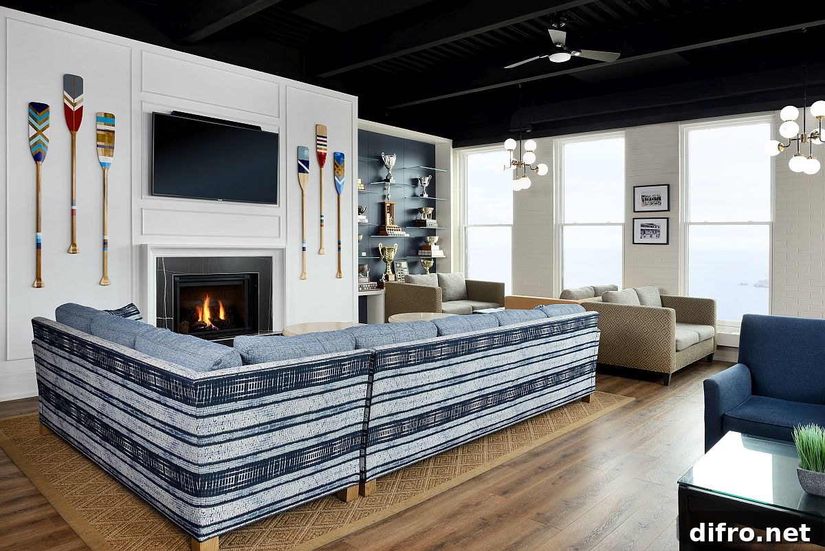 Striped couch and cozy fireplace with paddles on the wall