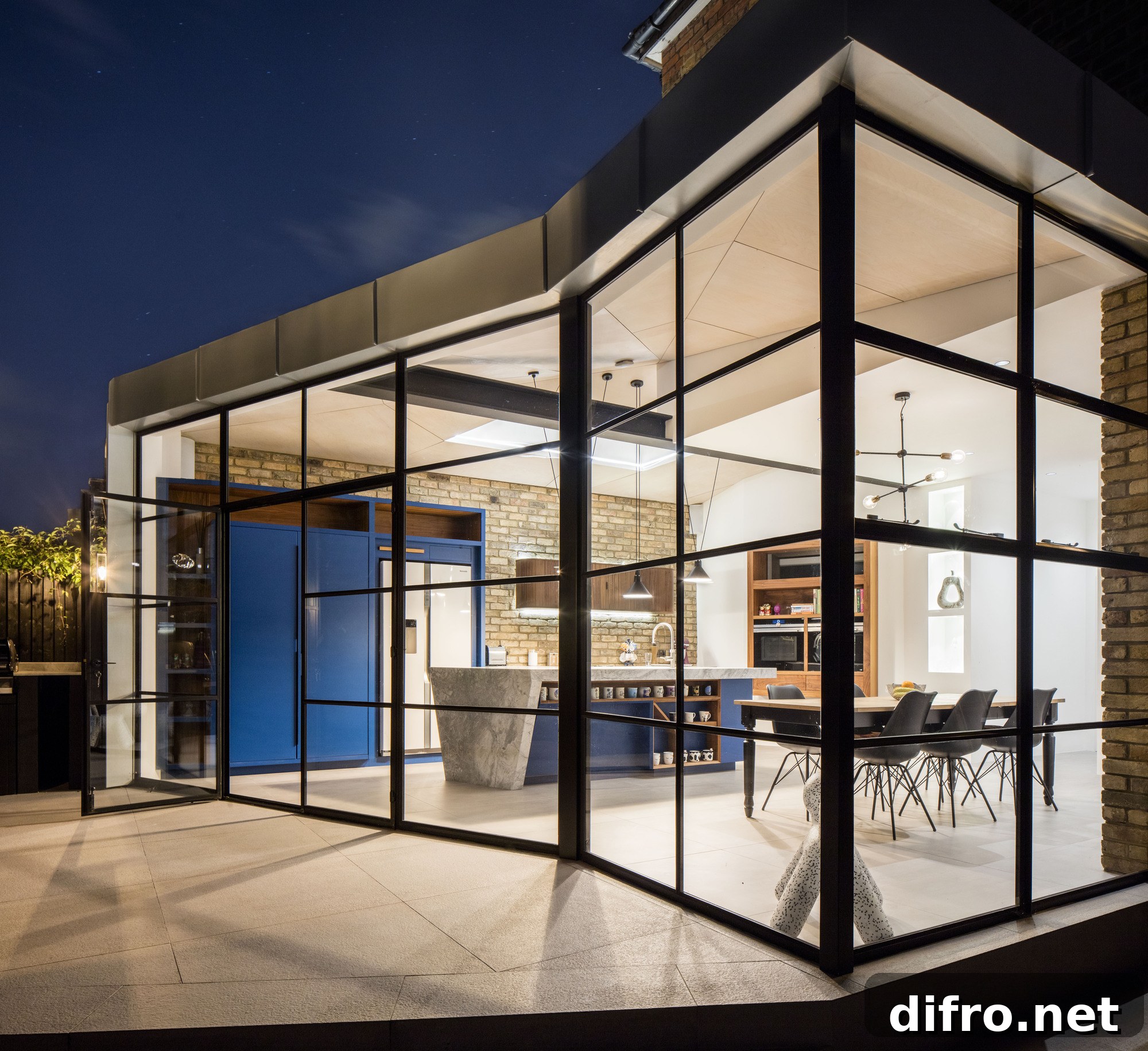 Angular roof design, zinc exterior and glass walls of the modern extension to Victorian home
