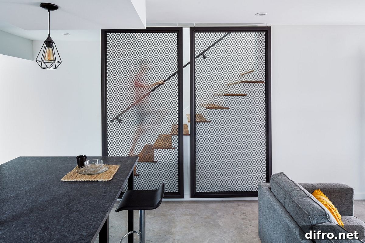 Metallic mesh structures hide the staircase leading to the upper level of the house