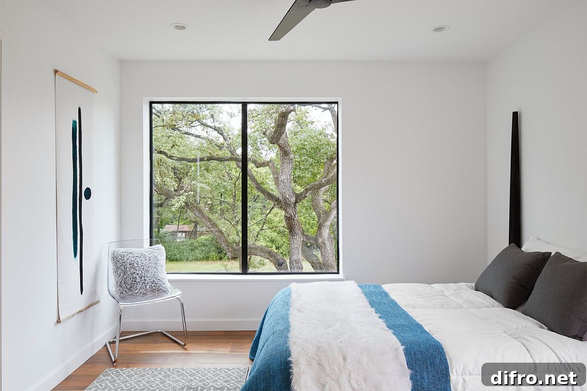 Modern bedroom in white of the Texas home with simple blue accents