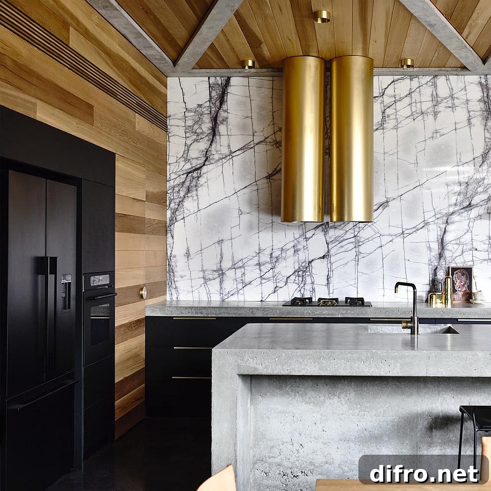 Kitchen with metallic hoods and marble backsplash