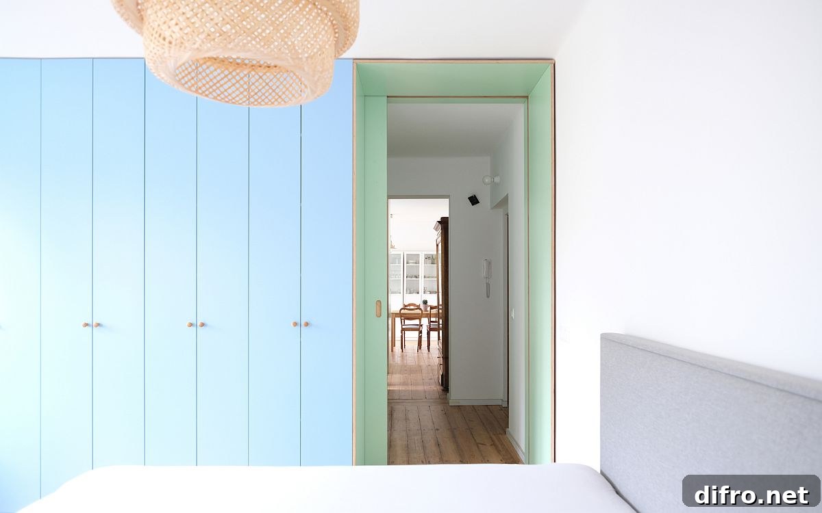 Living area at one end of narrow apartment and bedroom at the other