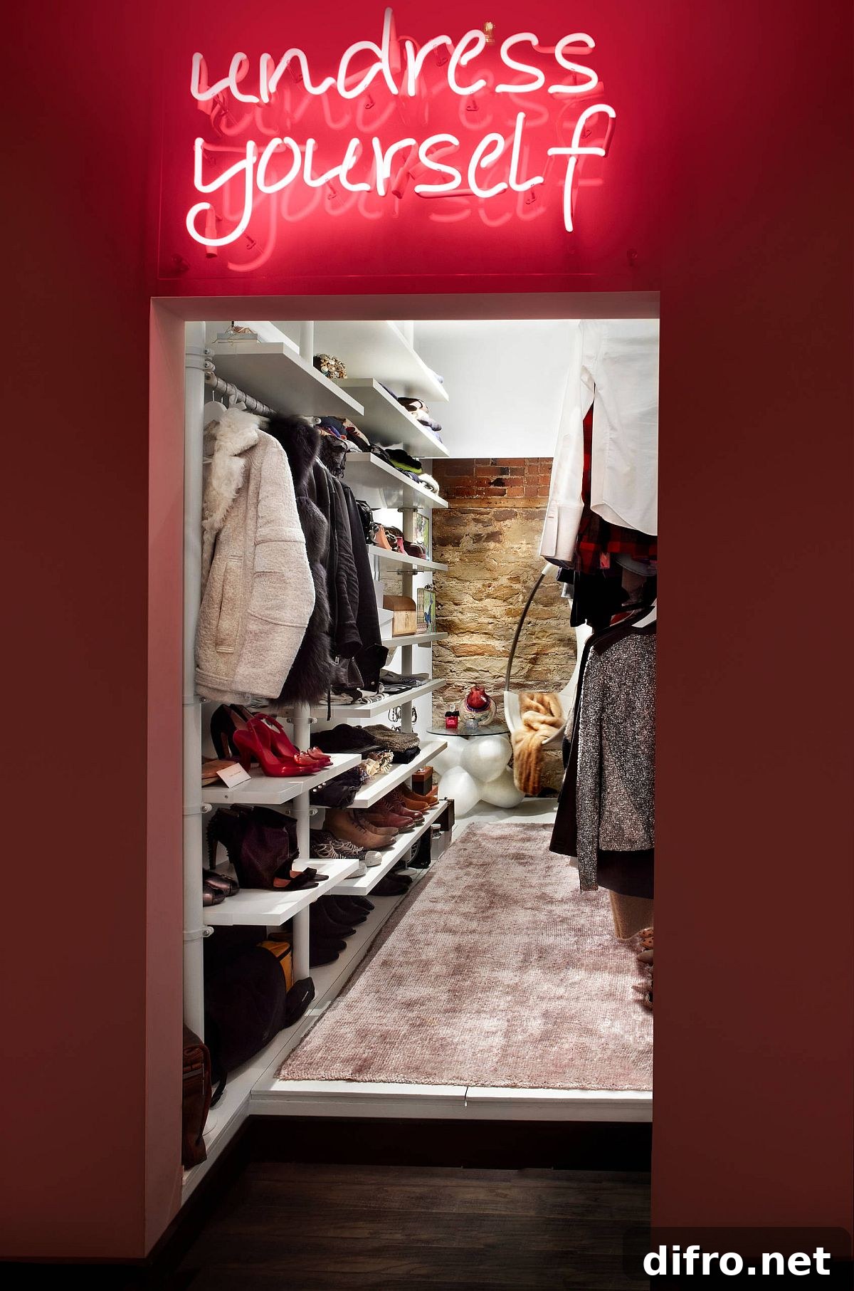 Chic closet with neon lighting and exposed brick