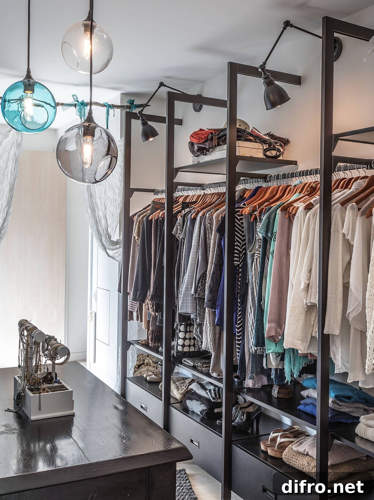 Open closets and warm lighting in a Toronto walk-in closet