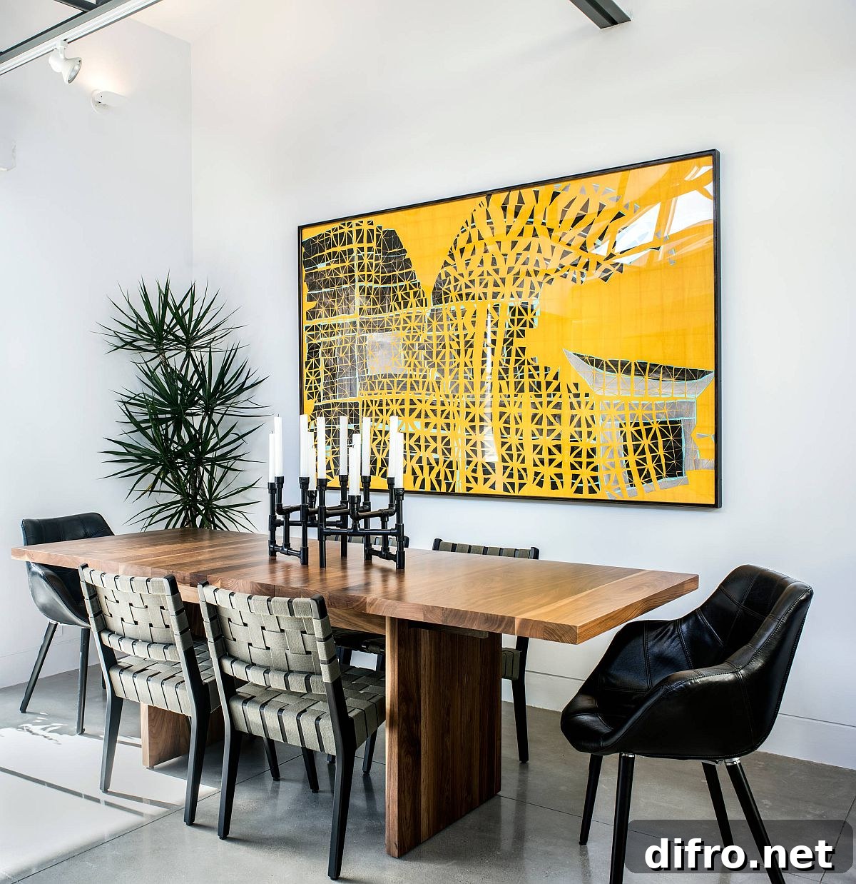 Black and white dining room with bright yellow art