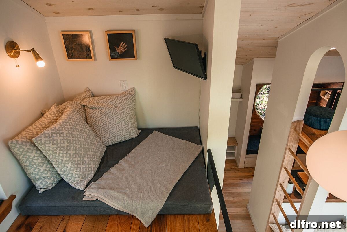 Loft level reading nook of the cabin with simple lighting and small relaxing area
