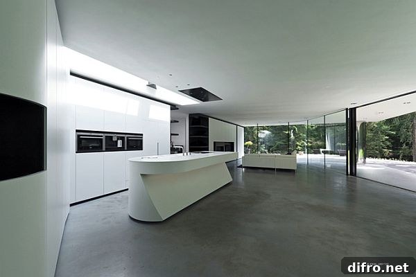 Frameless curved glass wall connecting living room to outdoors