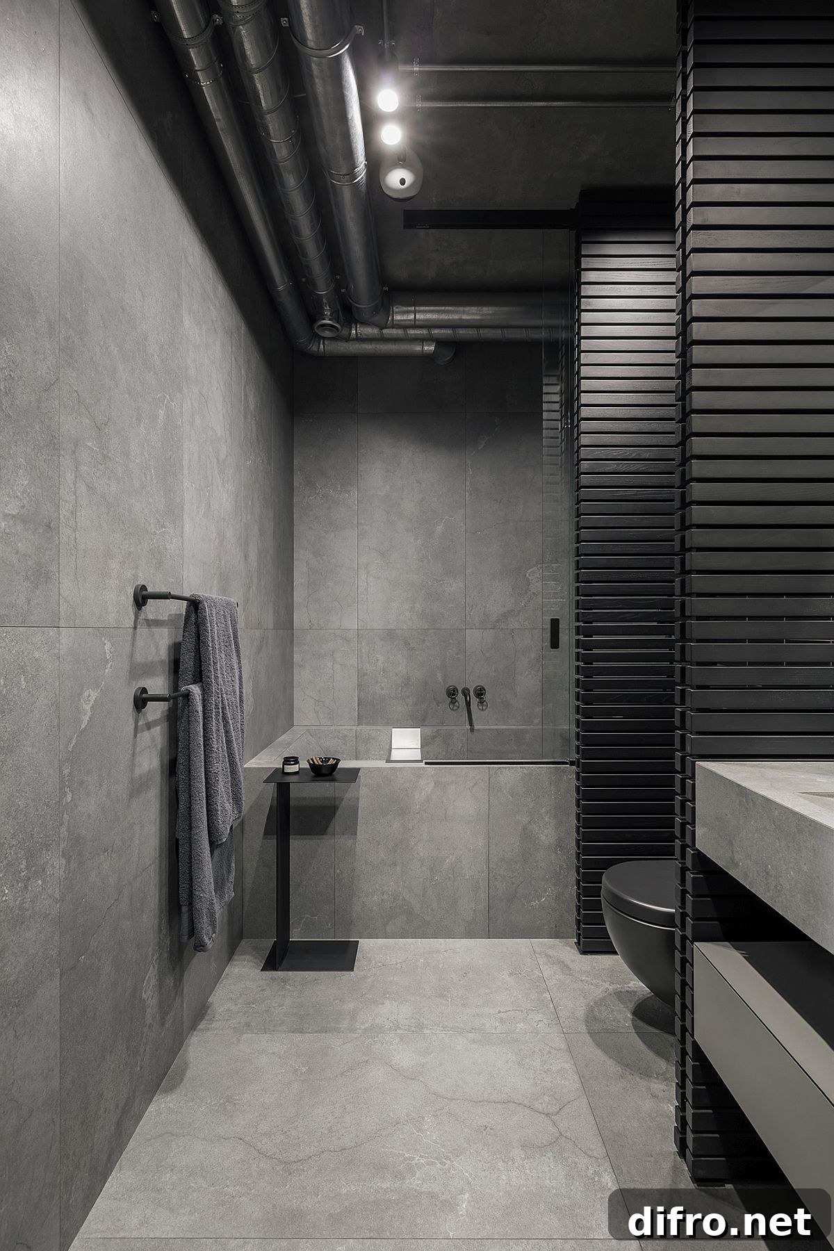 Dark gray and black contemporary bathroom with exposed duct pipes and natural stone
