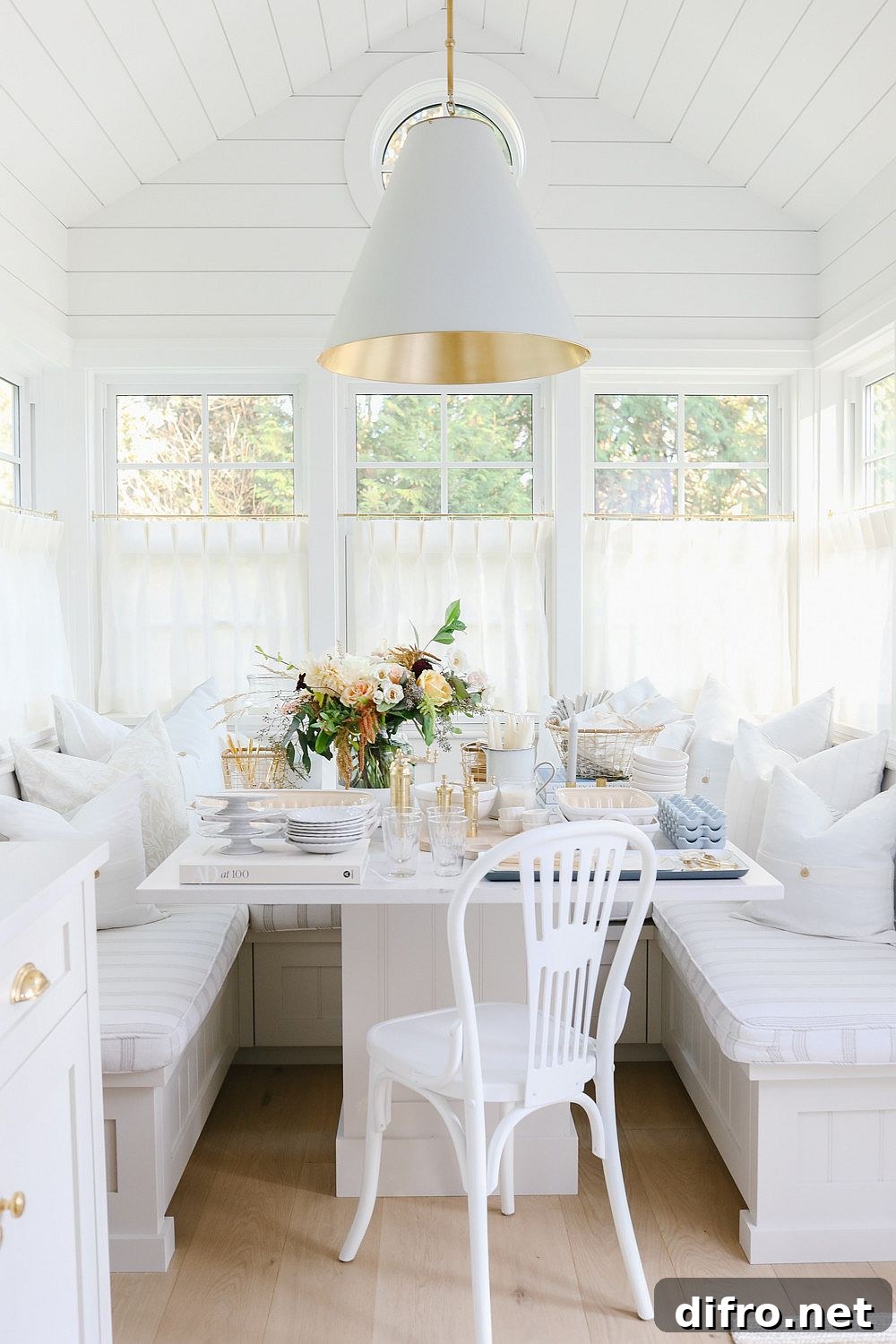Banquette seating in a space-savvy shabby chic dining area