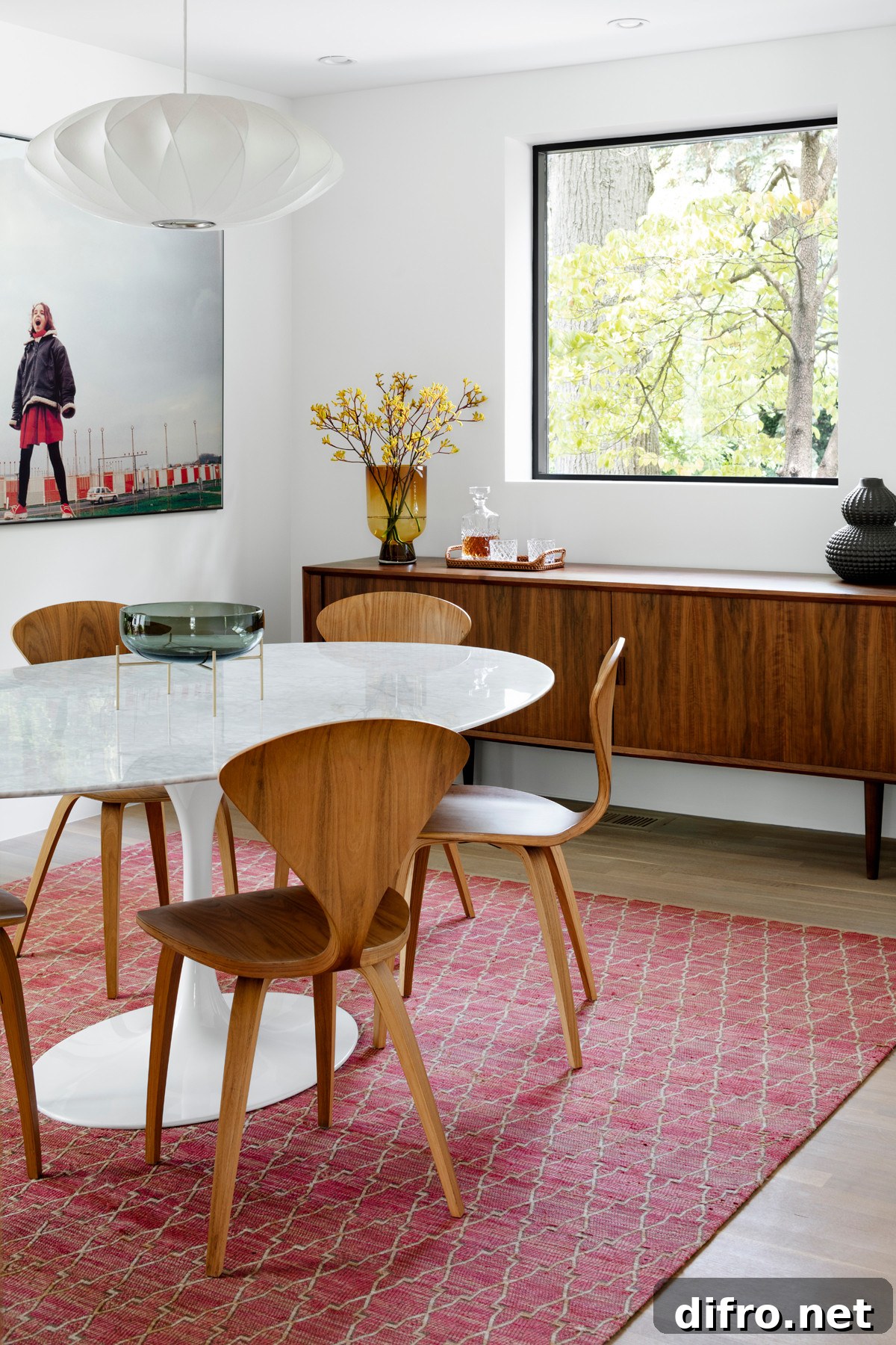 Dining room featuring curvy mid-century chairs