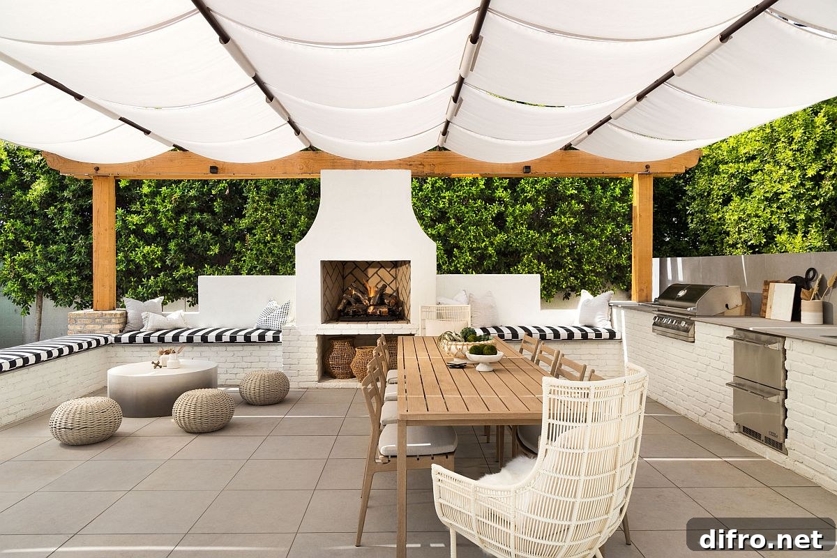 Outdoor living area with kitchen, fireplace and Mediterranean shade