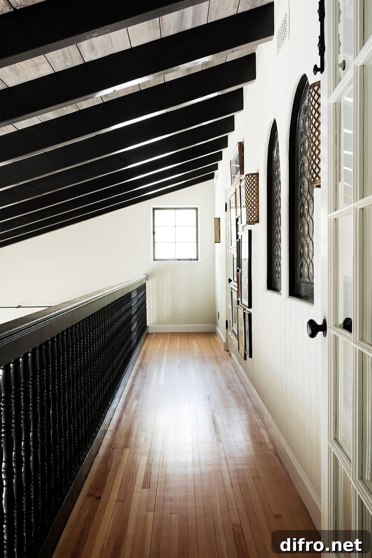 Hallway decorated with Mediterranean-style windows and gallery wall