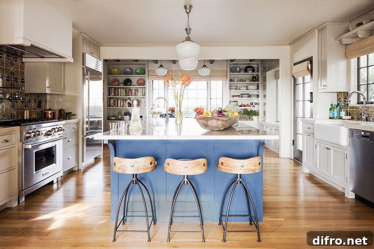 Pattern-filled tiled backsplash and blue island in the kitchen