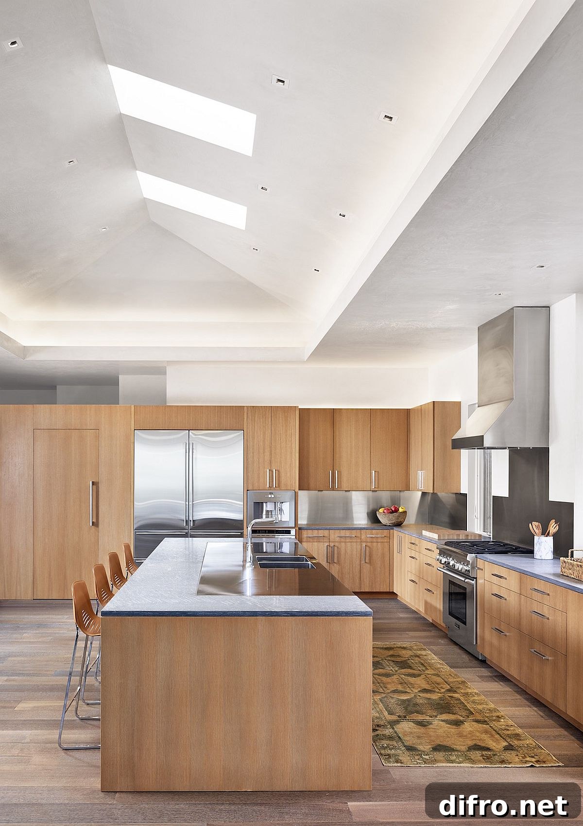 Double-height kitchen with skylights and glass doors