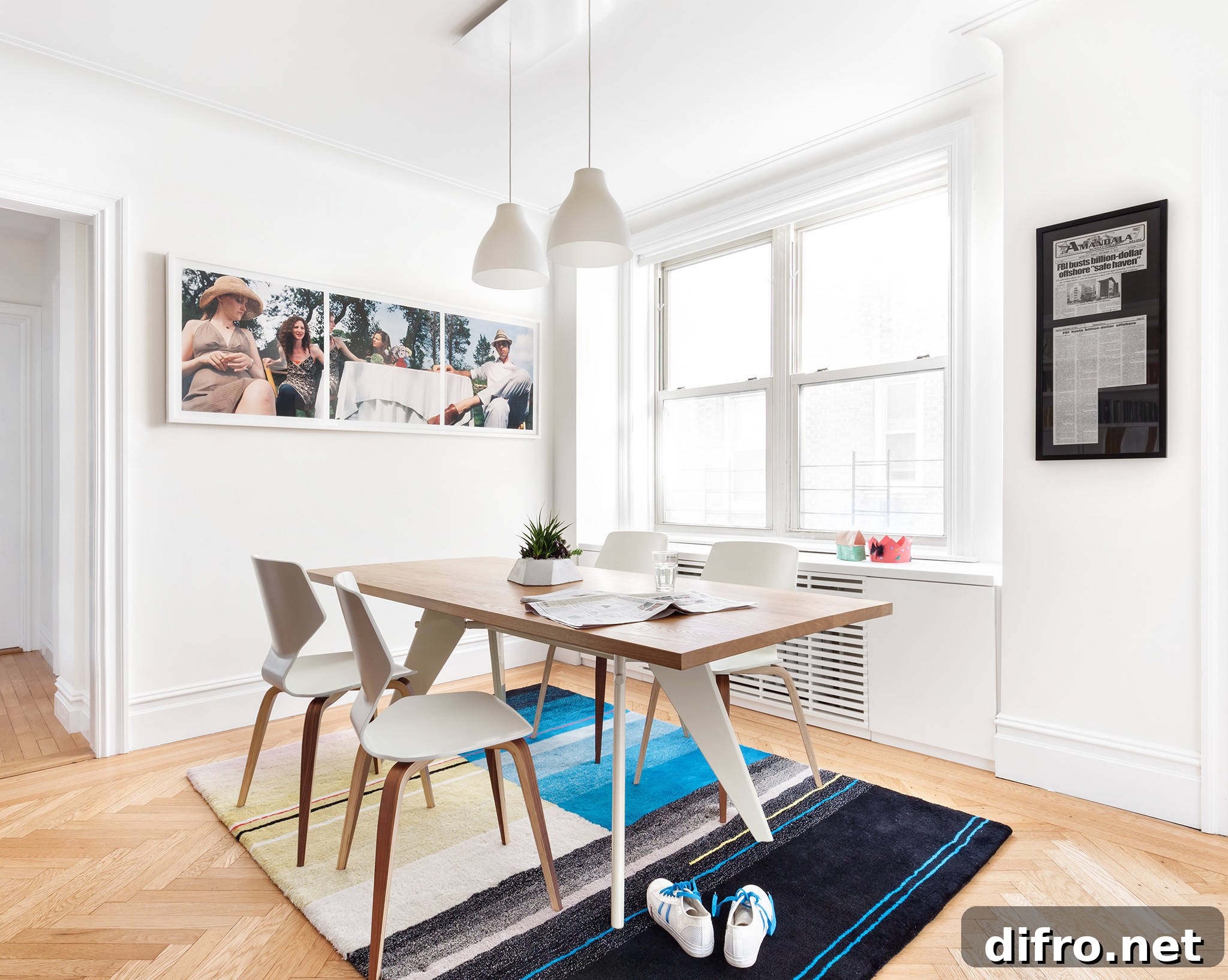 White dining room with rug and wall art
