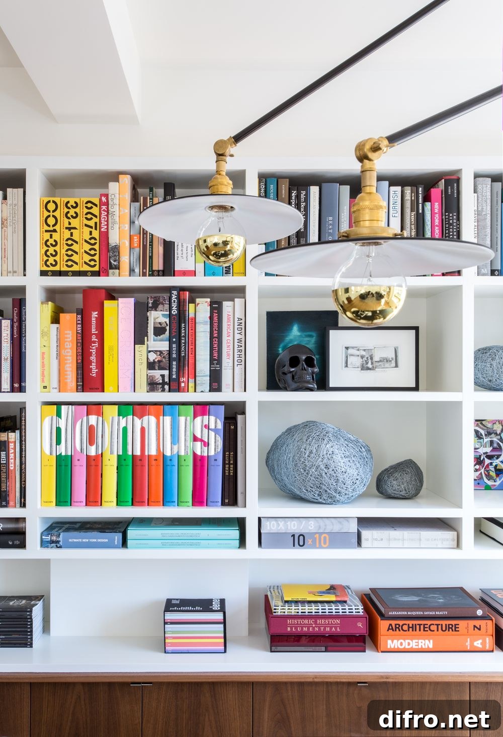 Guest bedroom with integrated shelving and storage that blends into the white backdrop