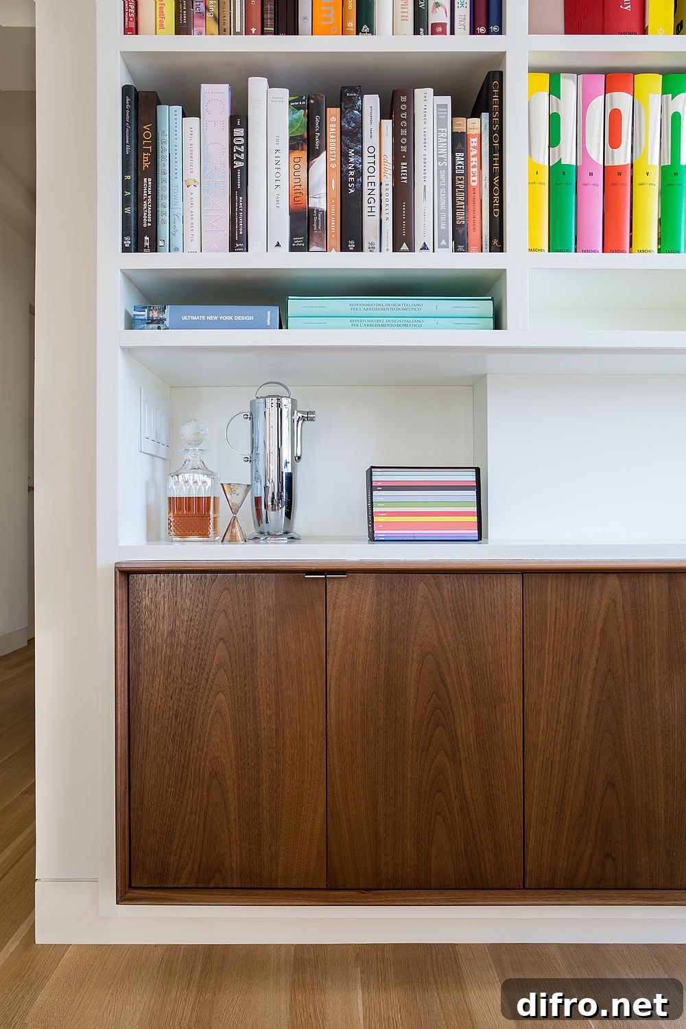 Wooden cabinets beneath open bookshelves create practical storage in the apartment