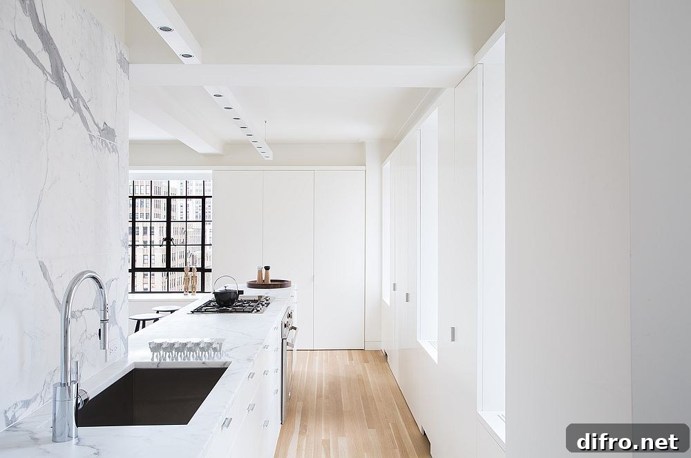 Exquisite white kitchen with marble countertops and white-lacquered cabinets