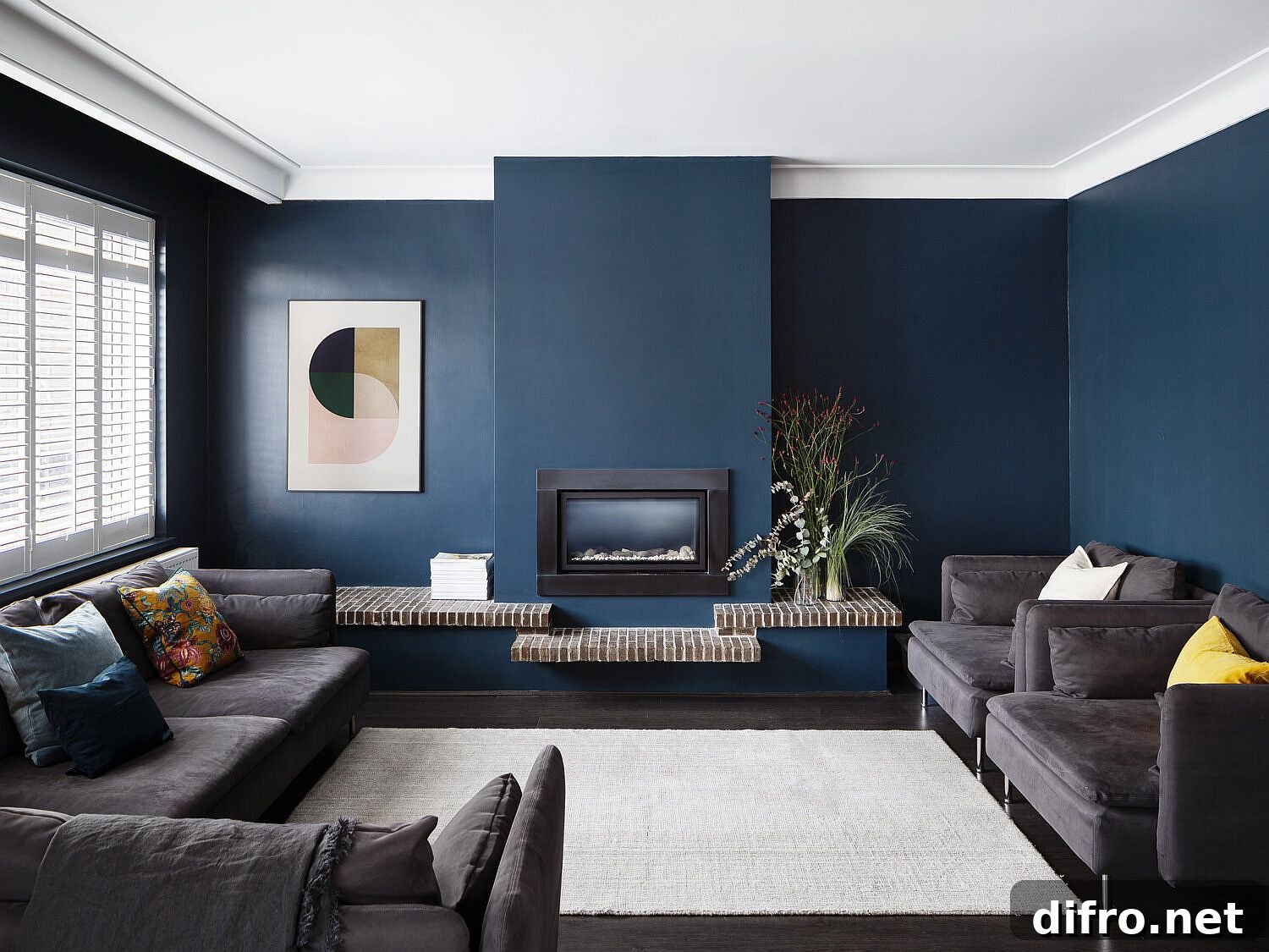 Fabulous dark blue living area with comfortable dark gray sofas and a small fireplace