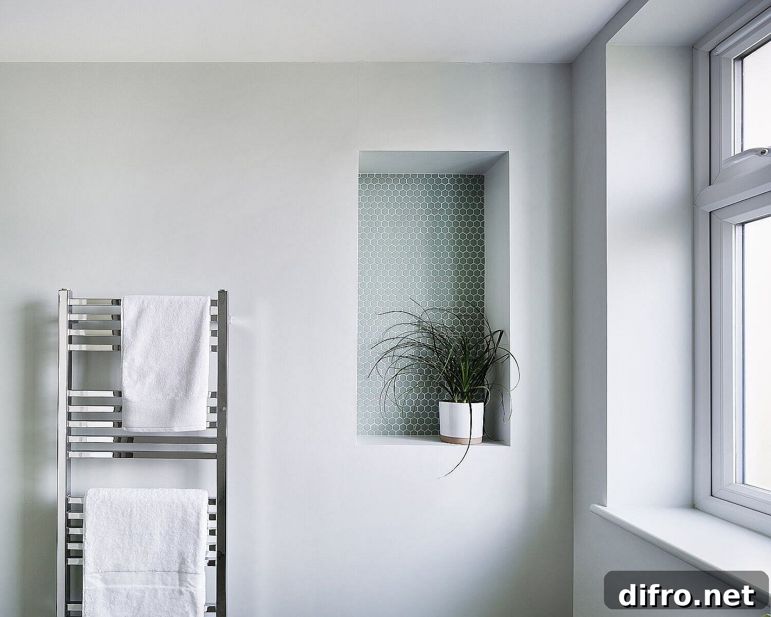 Little accent feature for the white modern bathroom with penny tiles and an indoor plant