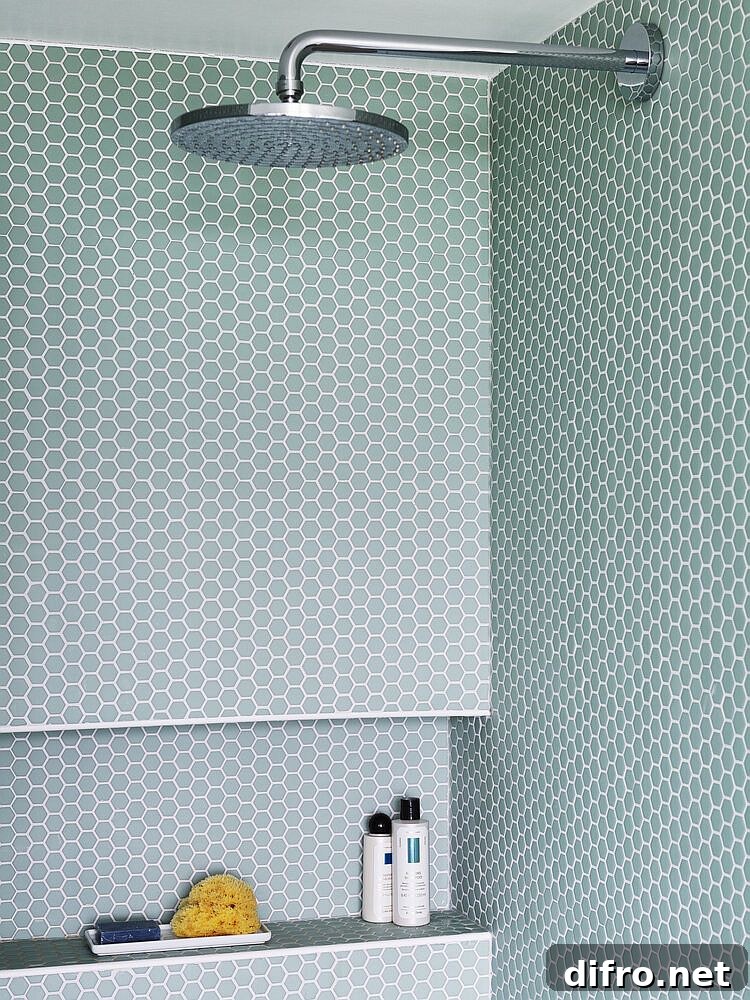 Modern bathroom shower area with penny tiles in pastel green