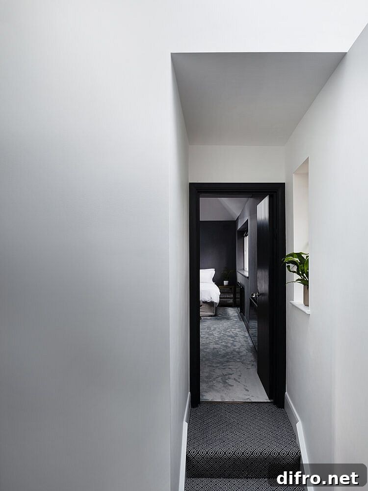 Corridor and staircase leading to the private upper level master suite of the revamped home in London