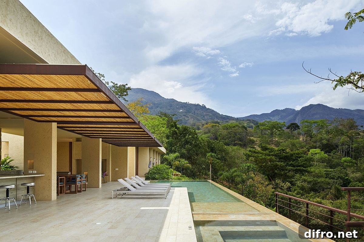 Pavilion-style kitchen, dining area and living space of the house become one with the pool and the deck