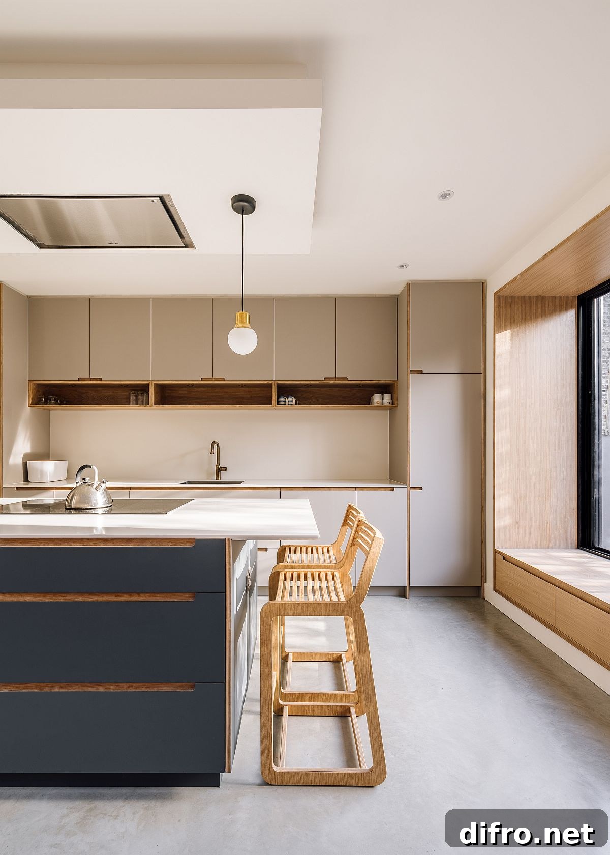 Bluish-gray central island of the spacious new kitchen with roof light