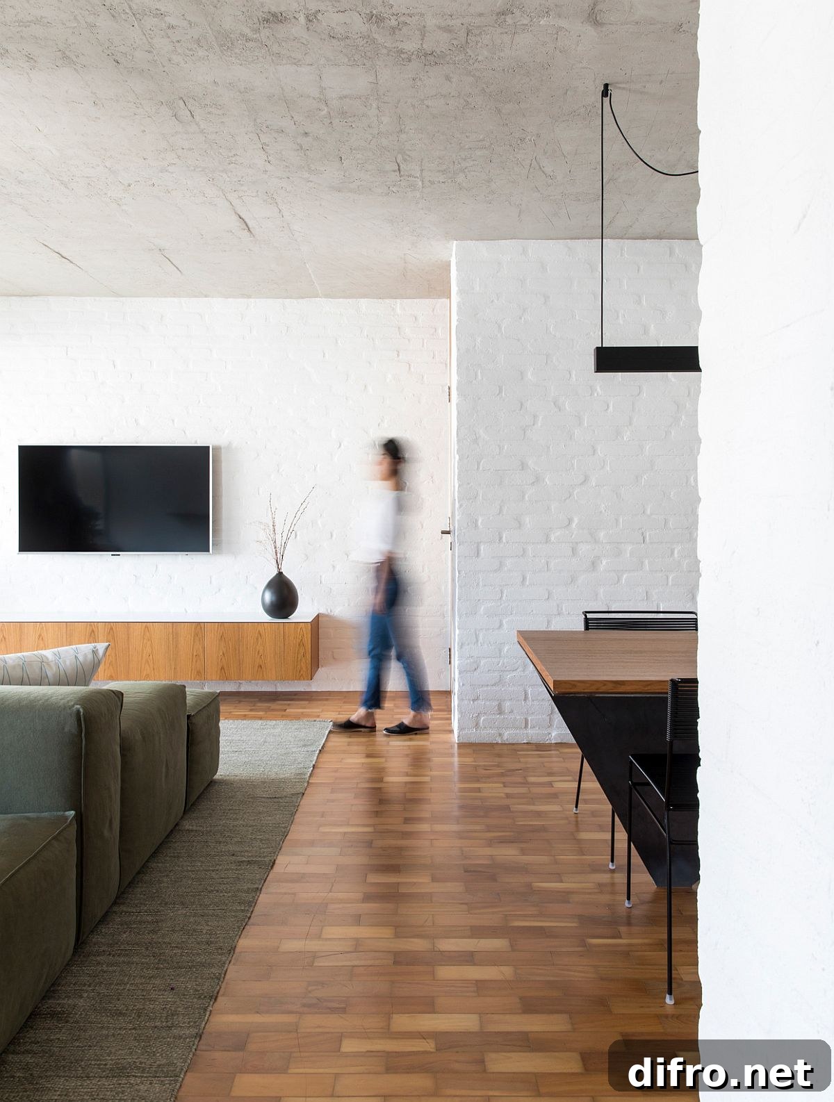Wooden floors combined with rugged exposed concrete ceiling and white painted brick walls