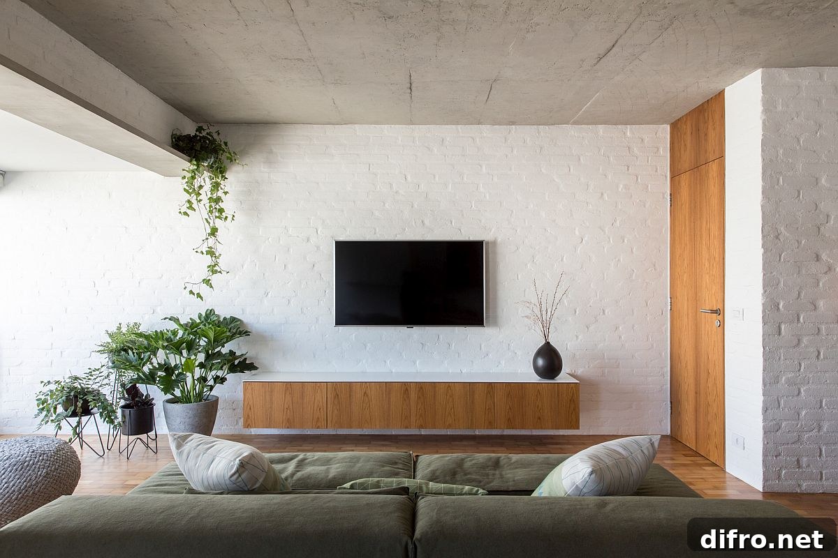 Modern industrial apartment interior with painted brick walls and exposed concrete ceiling