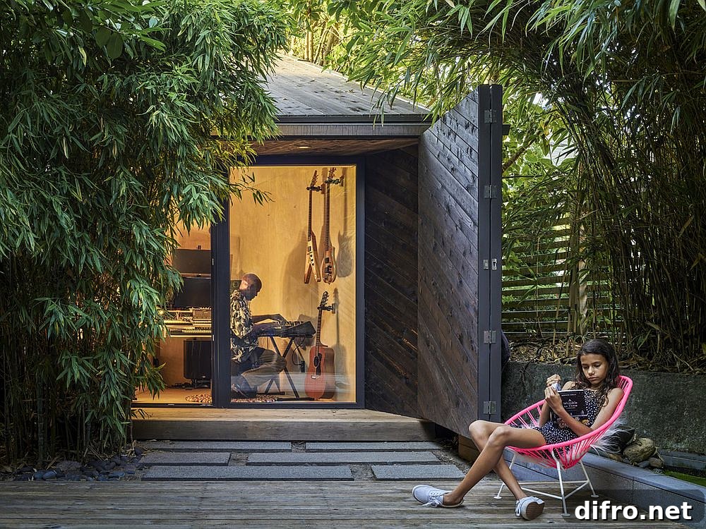 Tiny backyard music studio exterior with timber siding and glass