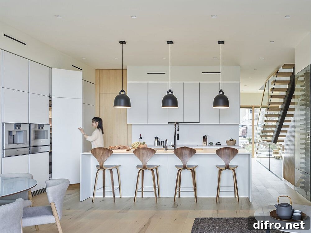 Modern kitchen in white and wood with dark pendant lights