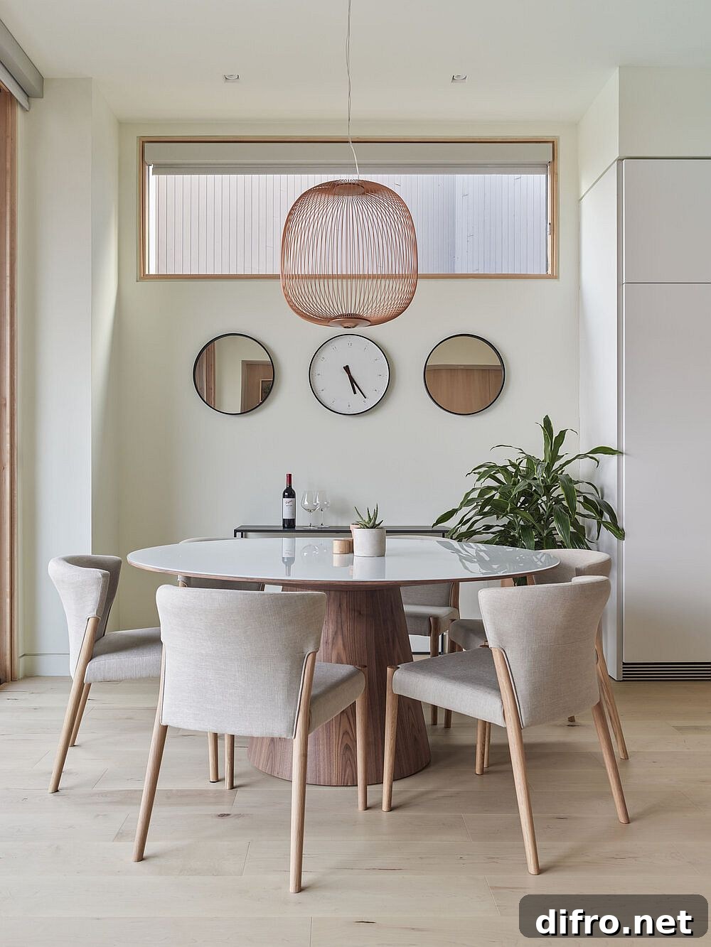 Minimal wood and white dining area with indoor plant and pendant light