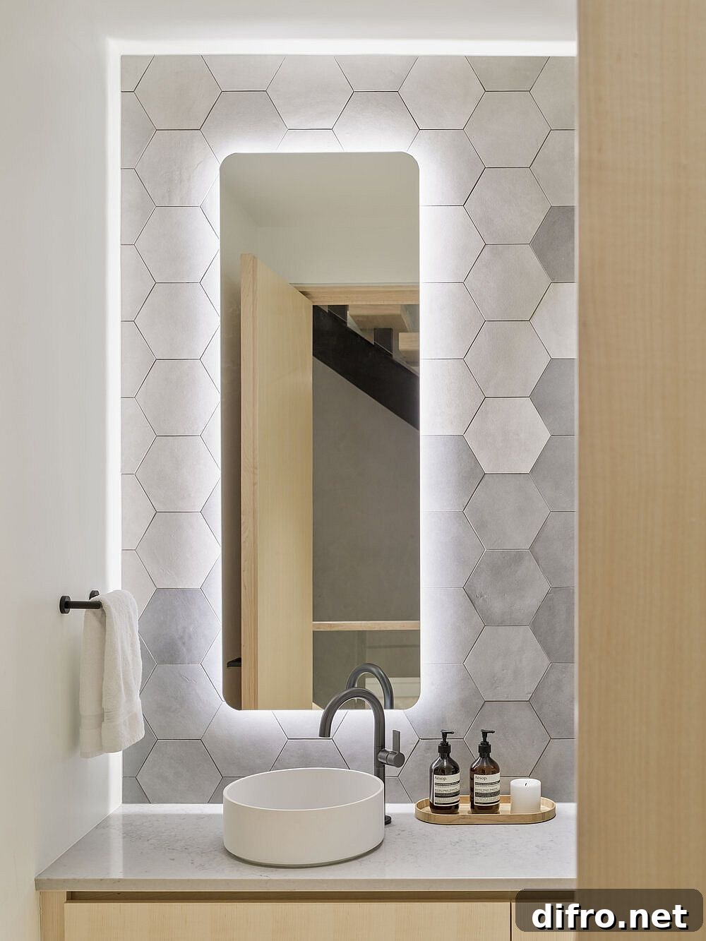 Gray hexagonal wall tiles in modern wood-and-white bathroom