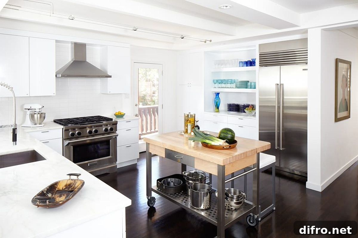 Wood-and-white kitchen with steel appliances and cart-style island