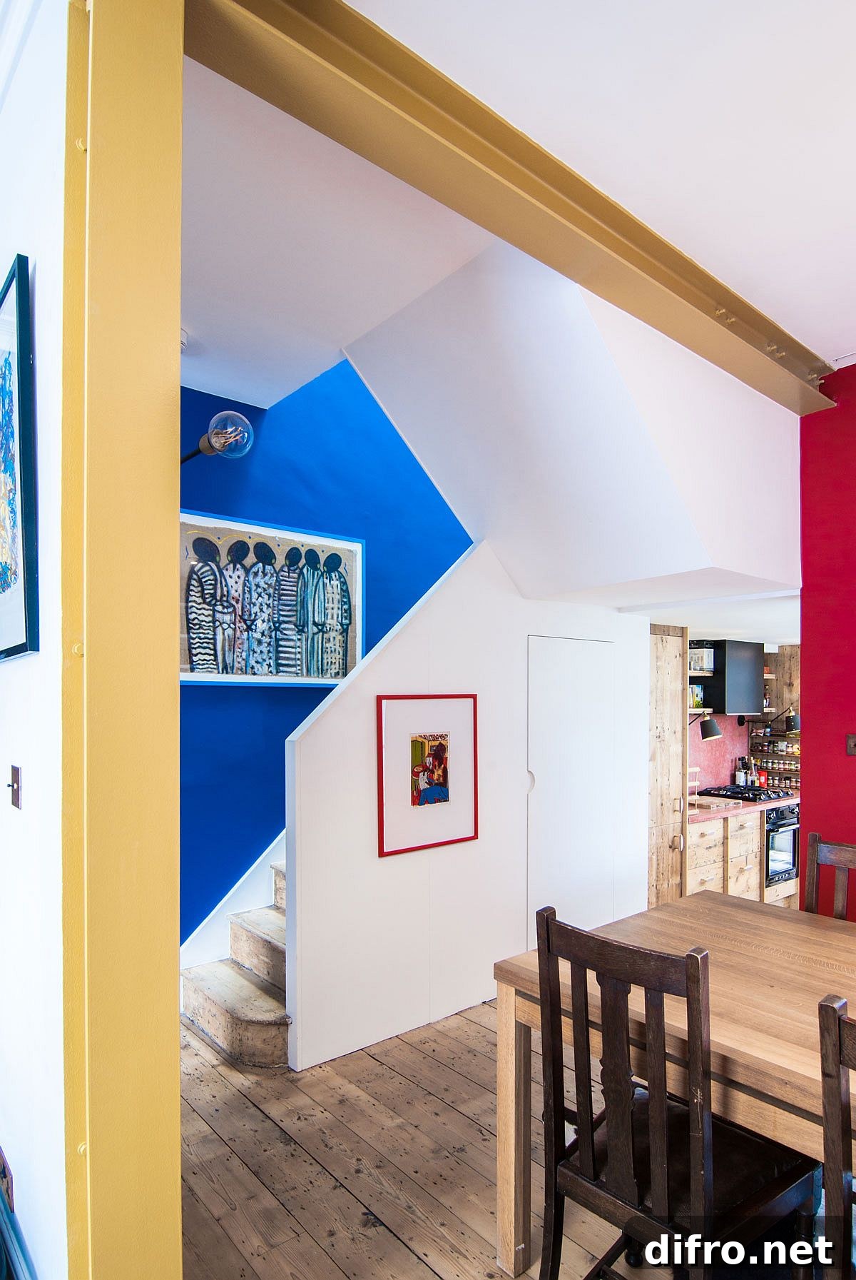 Blue staircase identity in open plan kitchen