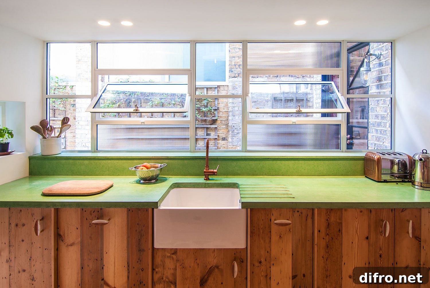 Green concrete countertop with reclaimed wood cabinets
