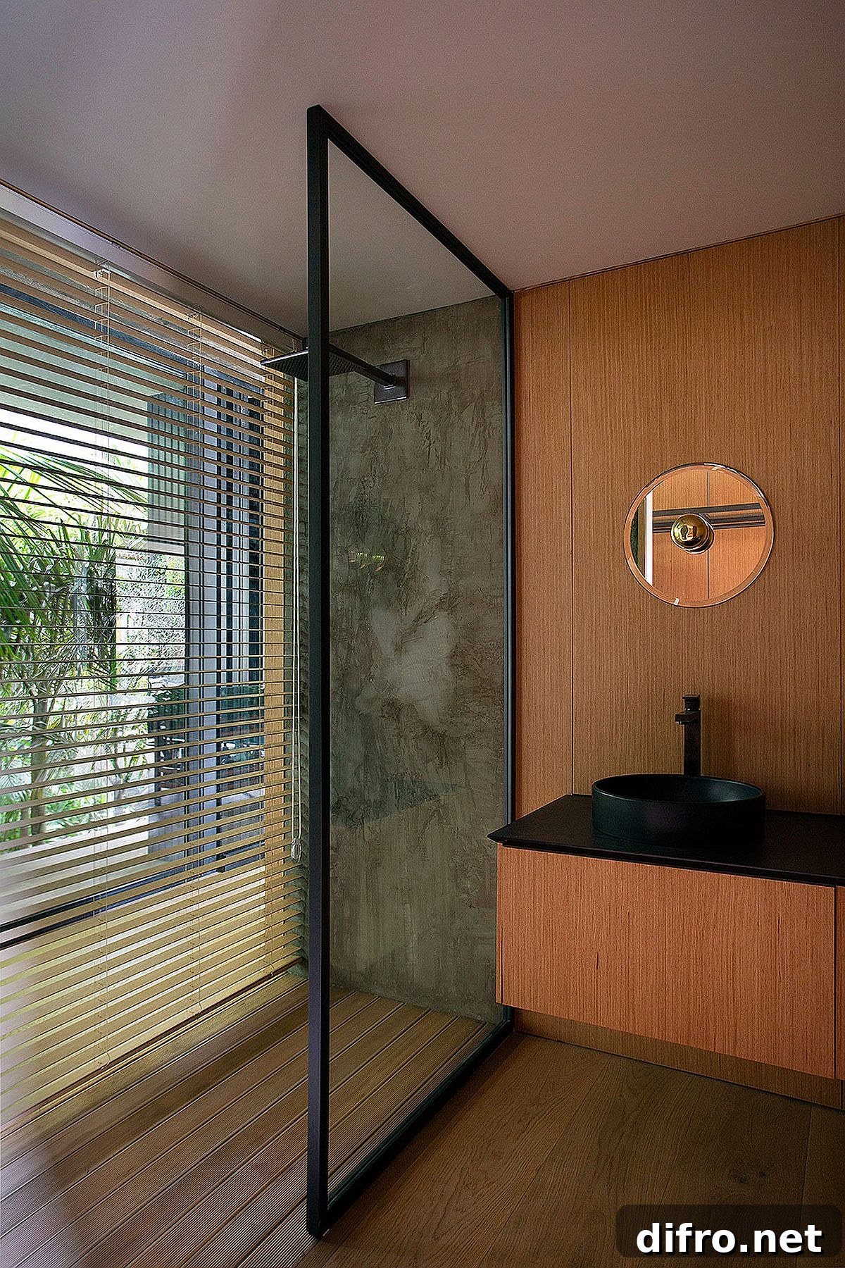 Black countertops with wooden vanity in modern bathroom