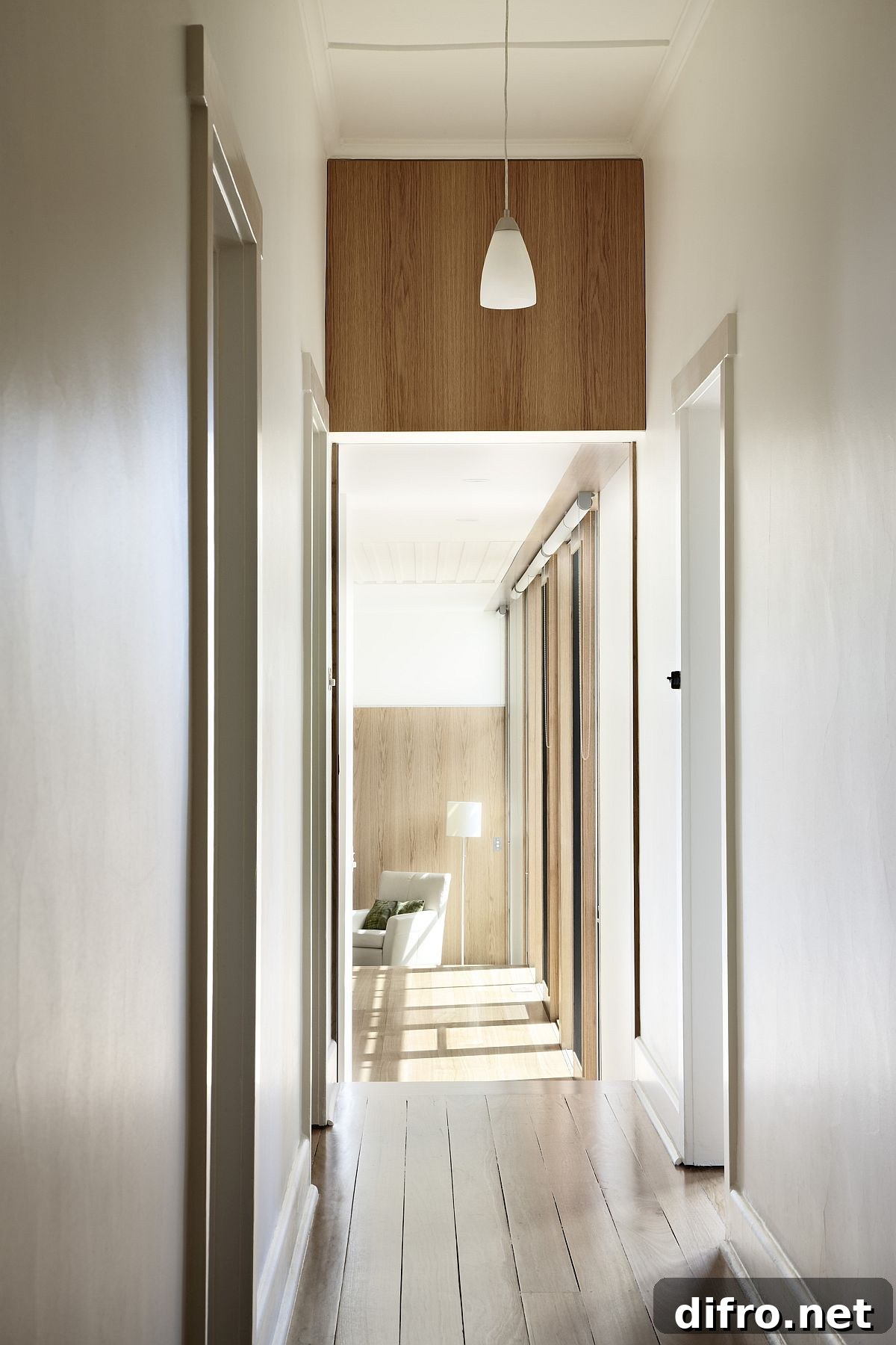 Long corridors in white and wood bring natural light into the home