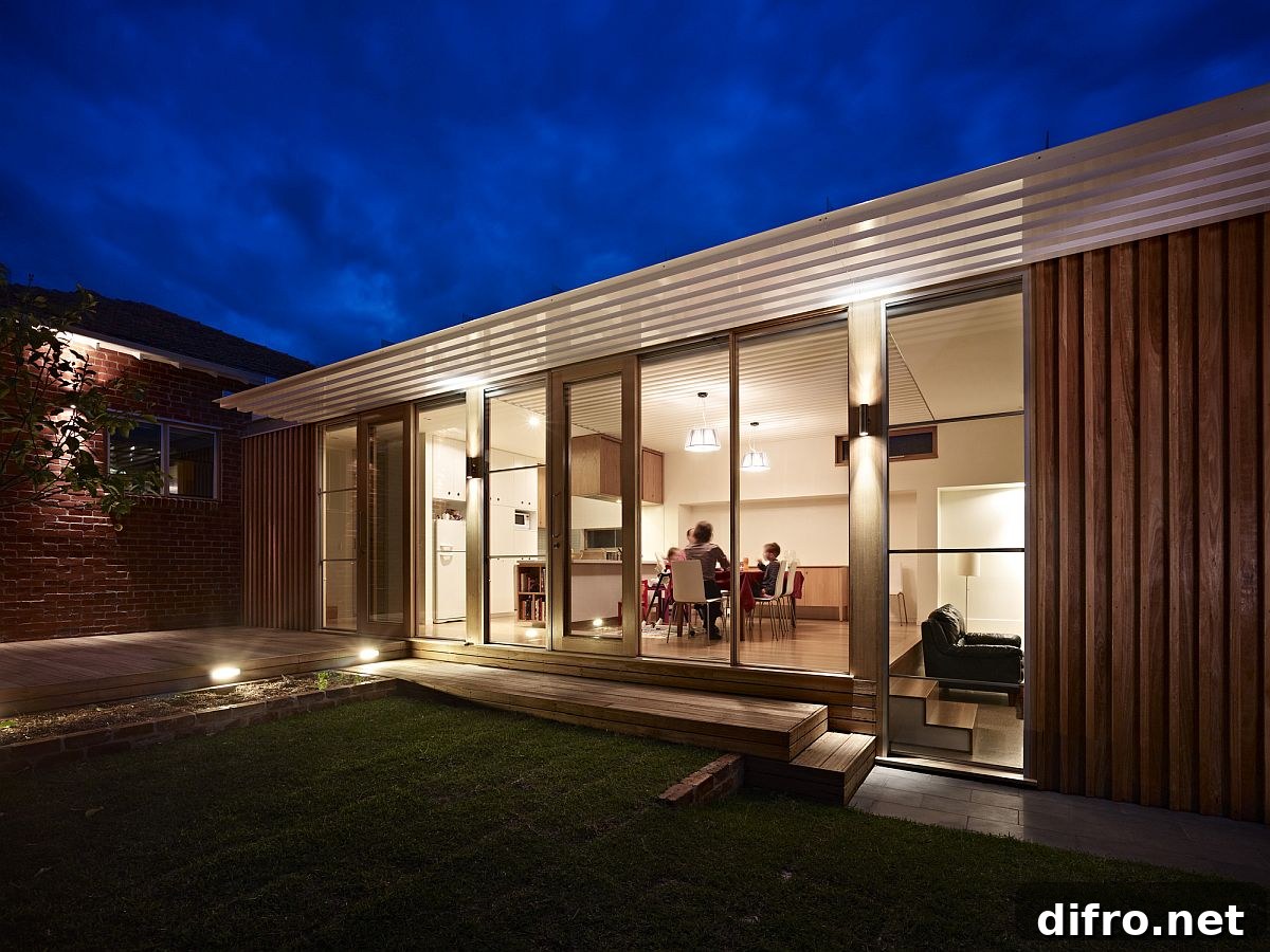 Warm lighting in the slim wooden extension