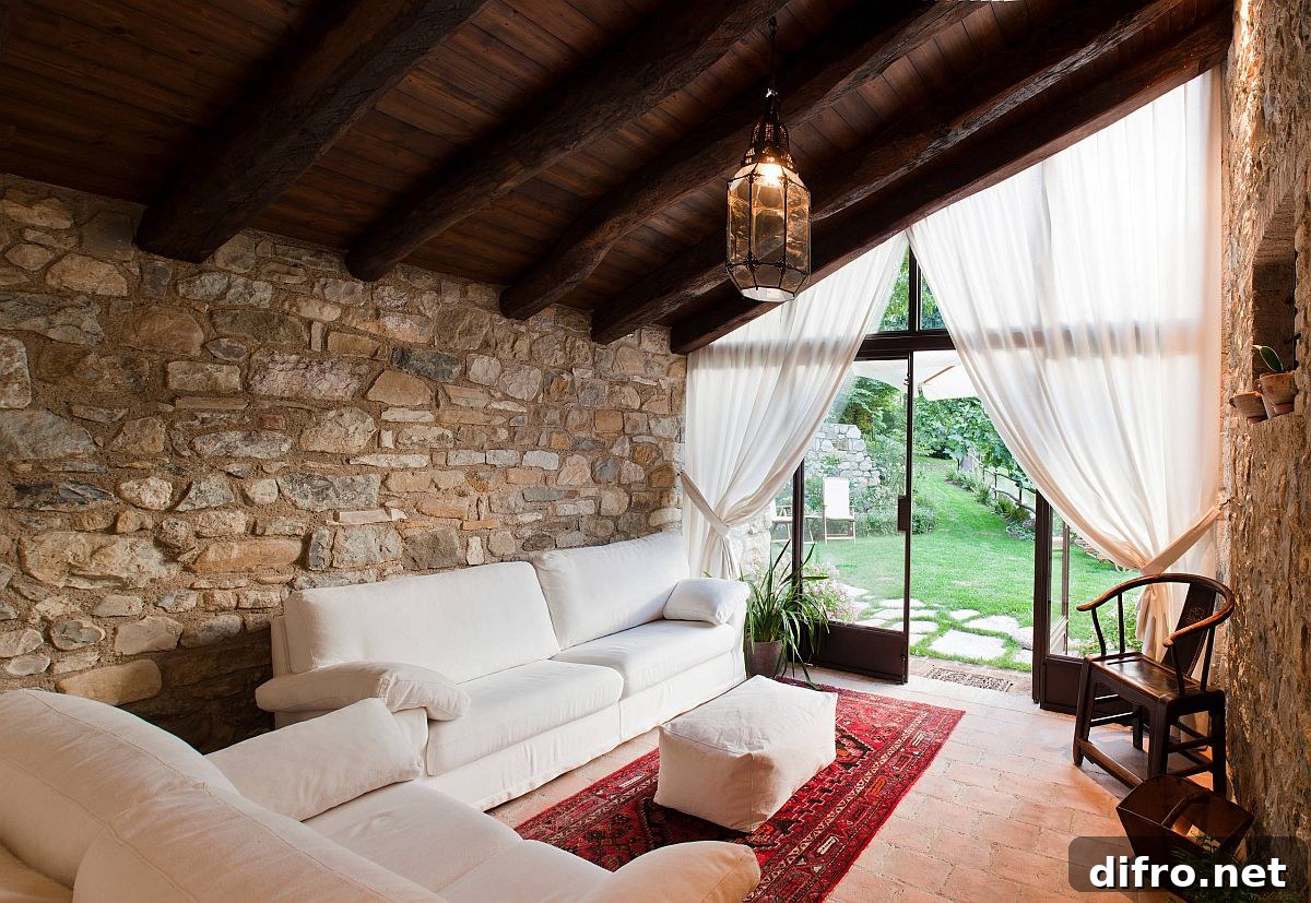 Elegant farmhouse style sunroom with terracotta floor and sheer curtains