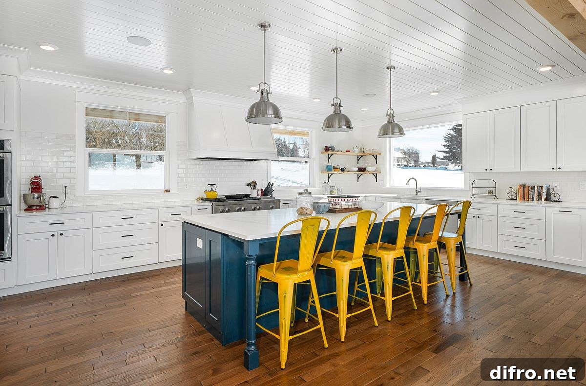 Blue kitchen island with yellow chairs