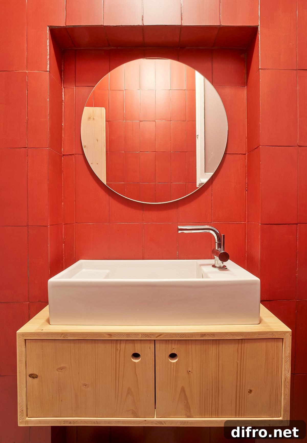 Red bathroom with a floating wooden vanity